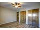 This bedroom features wood-look floors, a ceiling fan and double closets for maximum storage at 4605 E Valley View Dr, Phoenix, AZ 85044
