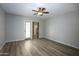 A spacious bedroom features wood-look floors, a ceiling fan, and access to the outdoor patio at 4605 E Valley View Dr, Phoenix, AZ 85044