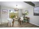 Bright dining room with modern chandelier, stylish furniture, and backyard view at 4605 E Valley View Dr, Phoenix, AZ 85044