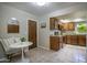 Eat-in kitchen features classic wood cabinetry, granite counters and a neutral tiled floor at 4605 E Valley View Dr, Phoenix, AZ 85044