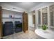 Convenient laundry room with side by side washer and dryer hookups and included overhead shelving at 4605 E Valley View Dr, Phoenix, AZ 85044