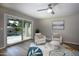 Cozy living area featuring a ceiling fan and sliding glass doors leading to the pool at 4605 E Valley View Dr, Phoenix, AZ 85044