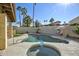 Backyard oasis featuring a sparkling pool, spa, and patio area surrounded by lush landscaping and palm trees at 4605 E Valley View Dr, Phoenix, AZ 85044