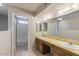 Dual sink bathroom with a shower, tile floor, and cabinets at 4608 W Maryland Ave # 122, Glendale, AZ 85301