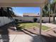 The well kept backyard has desert landscaping, a covered patio, and block fence at 4751 E White Aster St, Phoenix, AZ 85044
