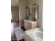 Dual sink vanity and a soaking tub in a well lit bathroom with attractive decorative touches at 4751 E White Aster St, Phoenix, AZ 85044