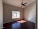 Bedroom featuring hardwood floors, vaulted ceiling, fan, and bright window at 4751 E White Aster St, Phoenix, AZ 85044