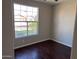 Inviting bedroom featuring wood flooring, a large window offering natural light at 4751 E White Aster St, Phoenix, AZ 85044