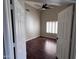 Bright bedroom showcases hardwood floors, ceiling fan, and plantation shutters at 4751 E White Aster St, Phoenix, AZ 85044