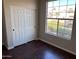 Comfortable bedroom with wood floors, ample closet space, and a bright window at 4751 E White Aster St, Phoenix, AZ 85044