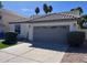 Attached two-car garage showcasing a clean driveway and manicured landscaping at 4751 E White Aster St, Phoenix, AZ 85044