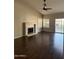 Living room showcases a fireplace, hardwood floors, fan, and sliding doors to the backyard at 4751 E White Aster St, Phoenix, AZ 85044