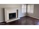Living room with fireplace, hardwood floors, plantation shutters, and lots of light at 4751 E White Aster St, Phoenix, AZ 85044