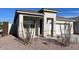 Inviting single-story home showcasing a covered porch, stone accents, and drought-tolerant desert landscaping at 4919 S 106Th Ave, Tolleson, AZ 85353