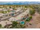 Wide aerial shot highlights the neighborhood and homes with backyard pools at 5332 W Linda Ln, Chandler, AZ 85226