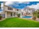 View of a charming two-story home with a refreshing blue pool and lush green lawn, perfect for outdoor relaxation at 5332 W Linda Ln, Chandler, AZ 85226
