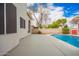 Backyard featuring a refreshing pool, concrete patio, and block wall, offering privacy and space for outdoor activities at 5332 W Linda Ln, Chandler, AZ 85226