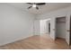 Minimalist bedroom with a ceiling fan, wood floors, and a double door closet at 5332 W Linda Ln, Chandler, AZ 85226