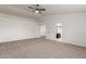 Spacious bedroom with neutral carpet, ceiling fan, and ensuite bathroom access at 5332 W Linda Ln, Chandler, AZ 85226