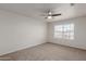 Bright bedroom with neutral carpet, a ceiling fan, and a bright window at 5332 W Linda Ln, Chandler, AZ 85226
