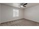 Bedroom with a neutral carpet, a ceiling fan, and a bright window at 5332 W Linda Ln, Chandler, AZ 85226