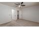 Bedroom with neutral carpet flooring and a ceiling fan with a walk-in closet at 5332 W Linda Ln, Chandler, AZ 85226