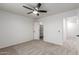 Neutral bedroom with a ceiling fan, carpet floors, closet and an ensuite bath at 5332 W Linda Ln, Chandler, AZ 85226