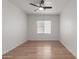 Minimalist bedroom with a ceiling fan, wood floors, and a window providing natural light at 5332 W Linda Ln, Chandler, AZ 85226
