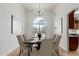 Formal dining room boasts large arched window, chandelier, and seating for eight, perfect for entertaining guests at 5332 W Linda Ln, Chandler, AZ 85226