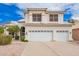 Picture showcases a home's front with a three-car garage and stone landscaping at 5332 W Linda Ln, Chandler, AZ 85226