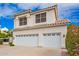 Frontal view of the home's garage and a glimpse of the landscaped yard, under a bright blue sky at 5332 W Linda Ln, Chandler, AZ 85226