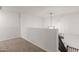 Lofted landing area with neutral carpet, railing and stairs at 5332 W Linda Ln, Chandler, AZ 85226