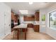 Well lit kitchen with oak cabinets, granite countertops, and a large island for dining at 5332 W Linda Ln, Chandler, AZ 85226