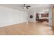 Open living room area with wood floors, a ceiling fan, and access to the kitchen and other rooms at 5332 W Linda Ln, Chandler, AZ 85226