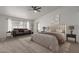Spacious main bedroom with neutral decor, ceiling fan, and cozy sitting area at 5332 W Linda Ln, Chandler, AZ 85226