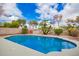 Inviting backyard pool surrounded by mature landscaping and blue skies, creating a serene oasis at 5332 W Linda Ln, Chandler, AZ 85226