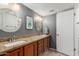 Bathroom boasting dual sinks, large decorative mirrors, warm cabinets and a stylish design, offering both elegance and functionality at 5518 E Lindstrom Ln # 2038, Mesa, AZ 85215