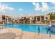 Large community pool with surrounding amenities and ample lounge seating at 5518 E Lindstrom Ln # 2038, Mesa, AZ 85215