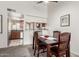 Cozy dining room with dark wood table and chairs, seamlessly connected to the kitchen through an open-concept layout at 5518 E Lindstrom Ln # 2038, Mesa, AZ 85215