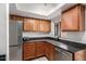 The updated kitchen features stainless steel appliances, dark countertops, and tiled floors at 5518 E Lindstrom Ln # 2038, Mesa, AZ 85215