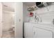 Functional laundry room with a stacked washer/dryer and convenient built-in shelving at 5518 E Lindstrom Ln # 2038, Mesa, AZ 85215