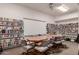 Community library featuring bookshelves filled with books and a large table with rolling chairs at 5518 E Lindstrom Ln # 2038, Mesa, AZ 85215