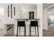 Stylish bar area with black bar stools and a wine rack, creating an ideal space for entertaining guests at 5518 E Lindstrom Ln # 2038, Mesa, AZ 85215