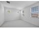 Bright bedroom features neutral carpet, white walls, and multiple windows offering natural light at 5710 N 84Th Ave, Glendale, AZ 85305