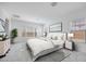 Serene bedroom with large windows, white linens, and neutral decor providing a relaxing atmosphere at 5710 N 84Th Ave, Glendale, AZ 85305