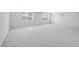 Bright bonus room features neutral carpet, white walls, and multiple windows offering natural light at 5710 N 84Th Ave, Glendale, AZ 85305