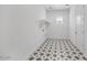 Laundry room features decorative tile flooring, a window and included shelving at 5710 N 84Th Ave, Glendale, AZ 85305