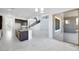 Bright living room with modern kitchen, spiral staircase, and sliding glass doors to patio at 5710 N 84Th Ave, Glendale, AZ 85305