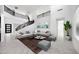 Spacious living room features a modern staircase, high ceilings, and ample natural light at 5710 N 84Th Ave, Glendale, AZ 85305