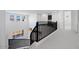 Hallway with a dark iron railing overlooking the entry and leading to multiple rooms at 5710 N 84Th Ave, Glendale, AZ 85305